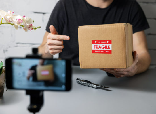 social media influencer recording product unboxing video. online
